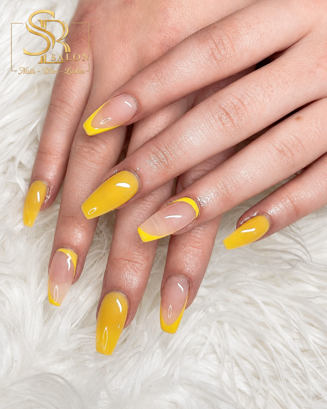 Coffin nails with bright yellow French tips and ombre nude base.