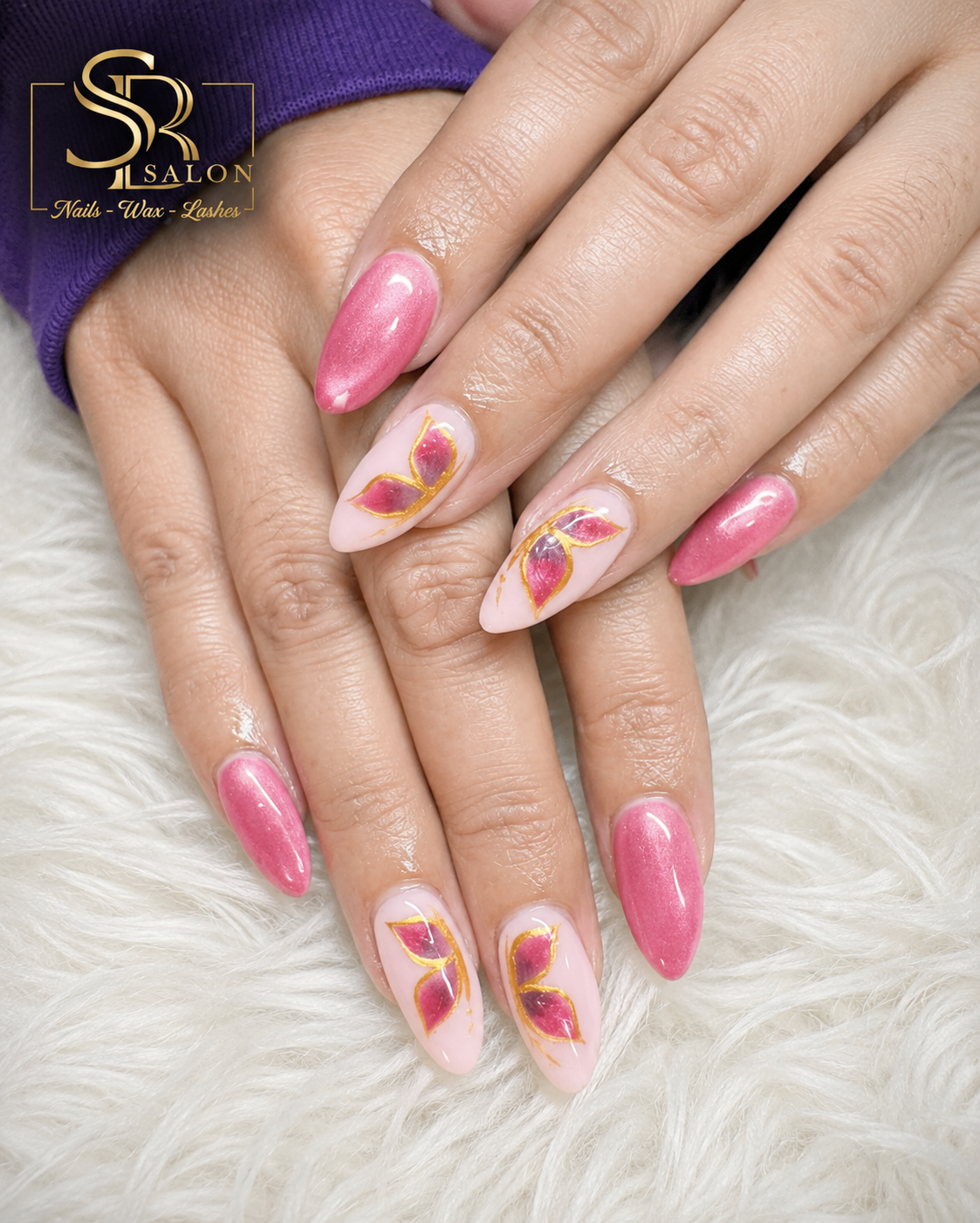 Shimmery pink almond nails with magenta and gold butterfly wing nail art accents.