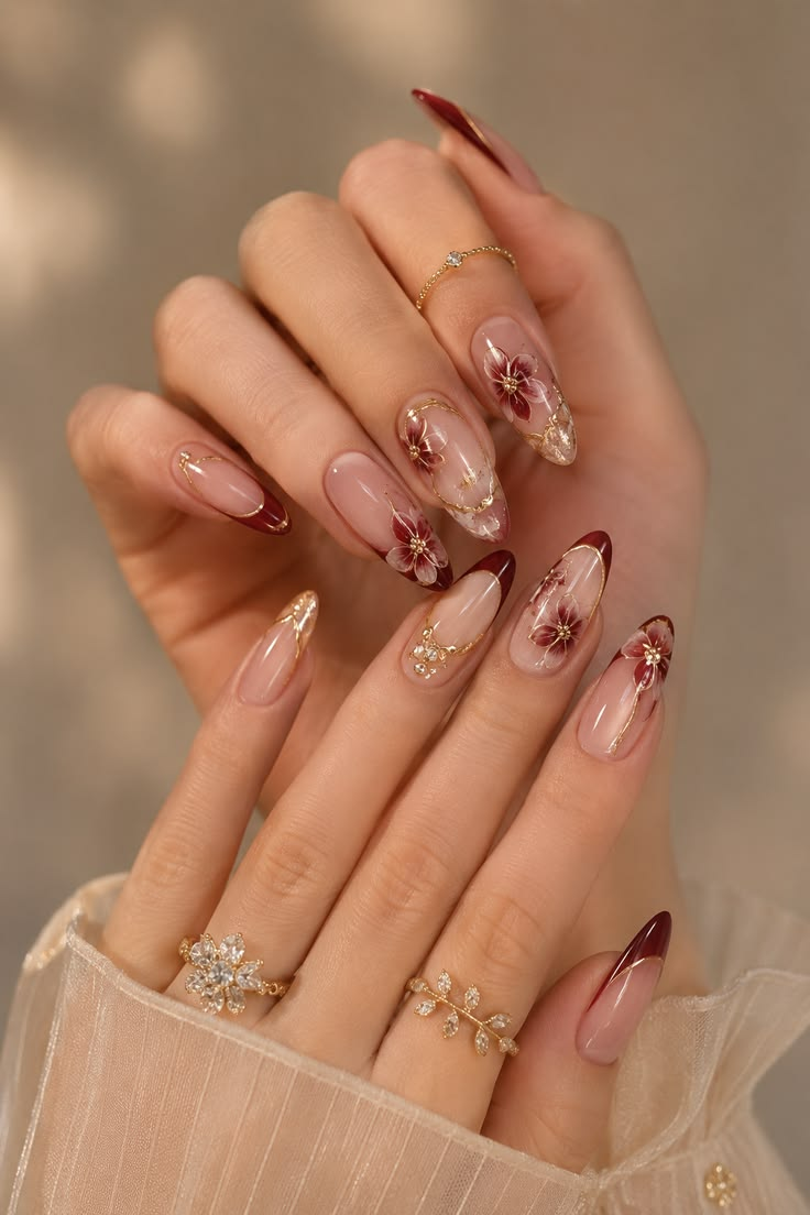 Burgundy floral gel nails with gold