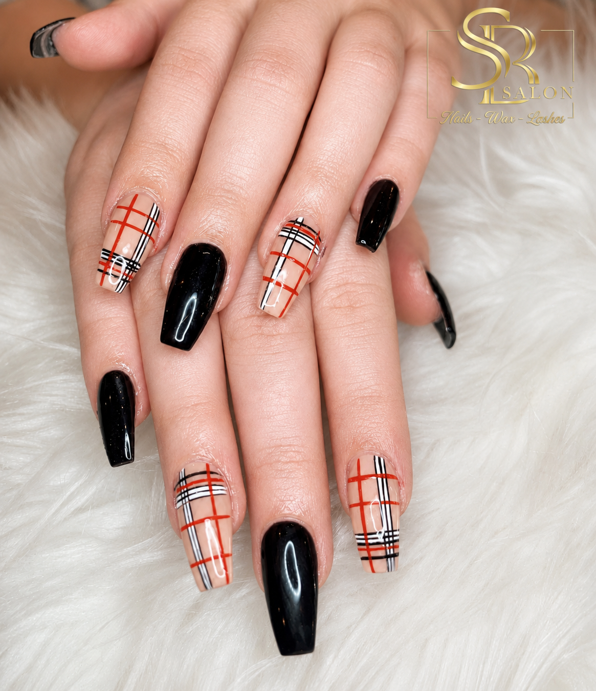 Long coffin nails alternating glossy black and Burberry-style red, black, and white plaid nail art on nude base.